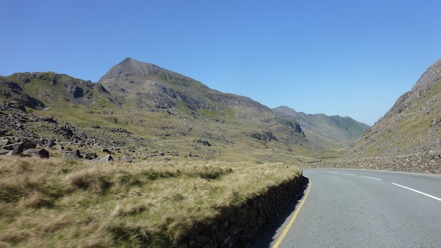 Winding road between mountains on a bright sunny day