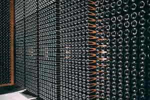 Free photo wine bottles stored in a winery on the fermentation process