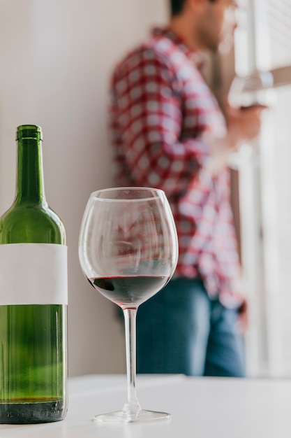 Wine glass and man at window