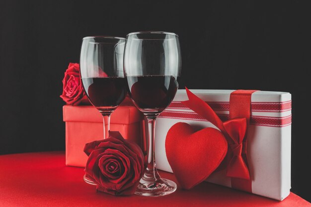 Wine glasses with gifts and a heart