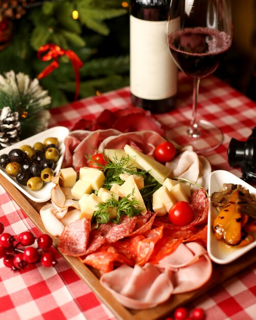 Wine snacks platter with sausages salami smoked meat slices cheese and olive