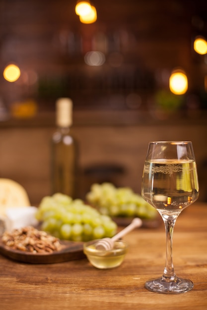 Wine tasting in a vintage restaurant with gorgonzola on a rustic wooden table. Fresh grapes.