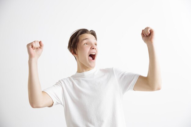 Winning success man happy ecstatic celebrating being a winner. Dynamic energetic image of male model