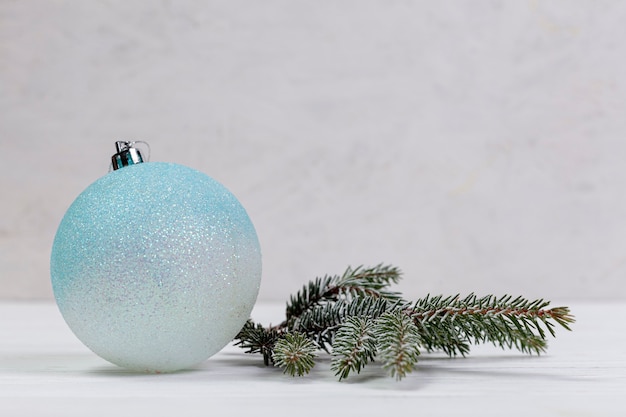 Free photo winter arrangement with globe and fir tree twig