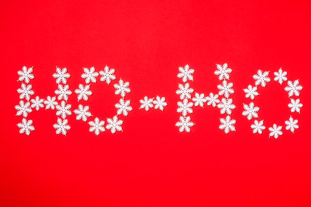 Winter background with snowflakes forming the word ho-ho