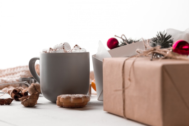 The winter composition. The gifts and cup with marshmallow