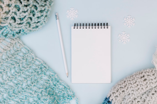 Free photo winter composition of notepad with scarf