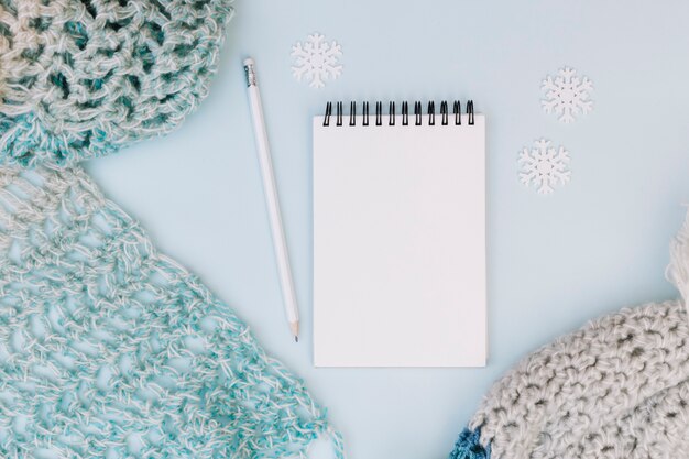 Winter composition of notepad with scarf 