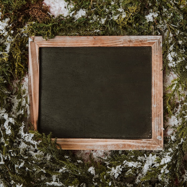 Free photo winter composition with slate in middle