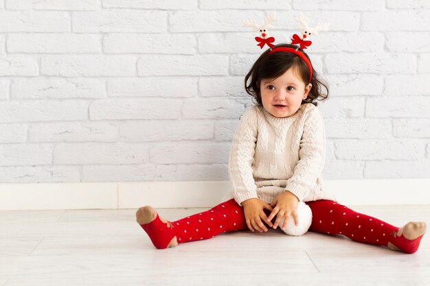 Free photo winter dressed girl playing with snowballs