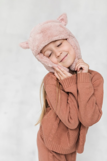 Winter dressed little girl fashion posing