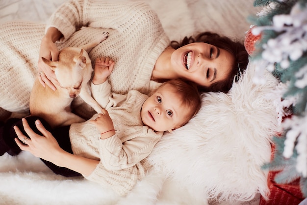 Winter holidays decorations. Warm colors. Family portrait. Adorable mom and daughter 