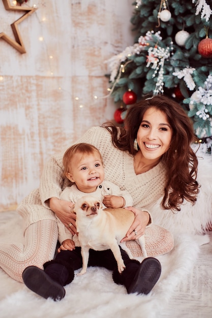 Winter holidays decorations. Warm colors. Family portrait. Adorable mom and daughter 