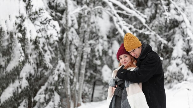 Winter landscape with couple hugging