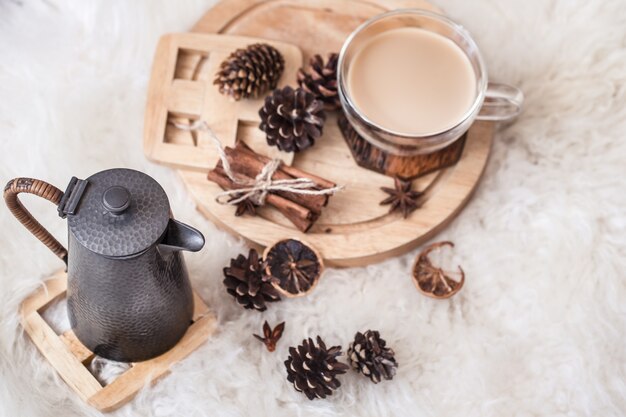 winter still life with cones and a hot drink with a teapot . The view from the top. The concept of comfort