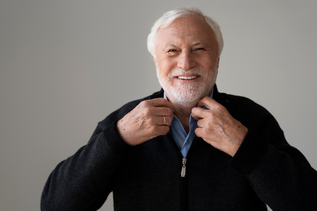 Free photo wise man posing in studio front view