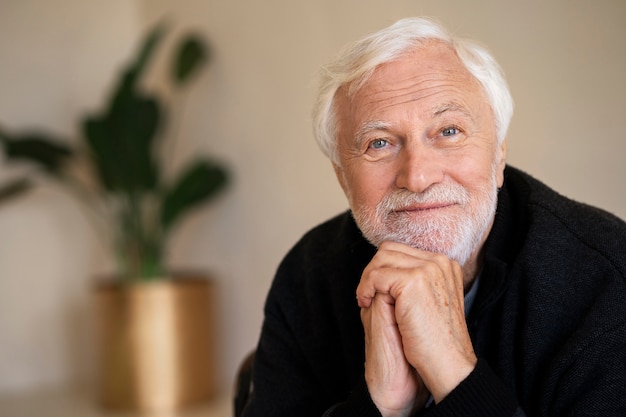 Wise senior man posing indoors front view