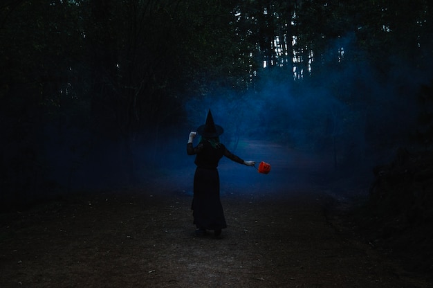 Witch dancing in dark forest