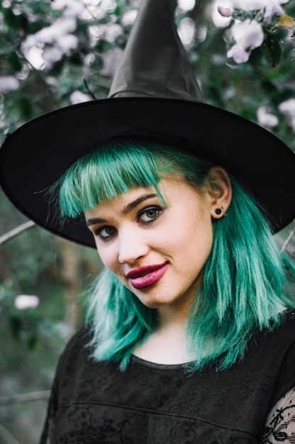 Free photo witch in hat looking at camera