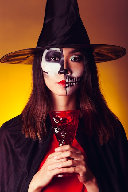 Free photo witch holding cup