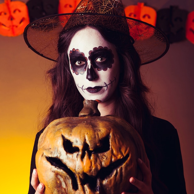 Witch holding pumpkin