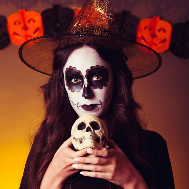 Witch holding skull