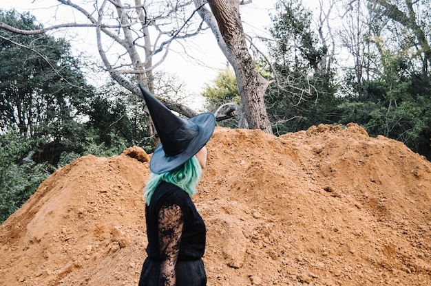 Witch at pile of ground