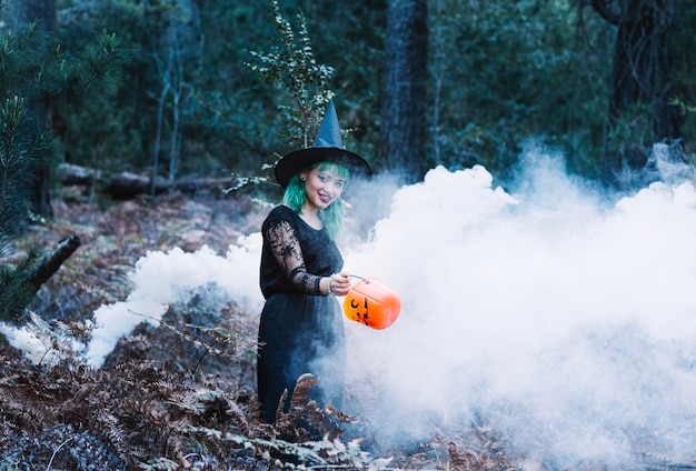 Witch in smoke in forest