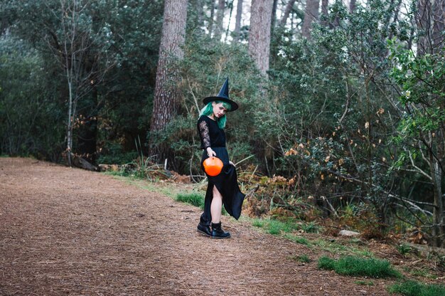 Witch standing on wood path