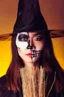 Free photo witch with broom and mask