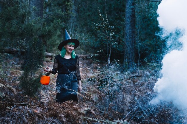 Женщина-ведьма при дыме в лесу