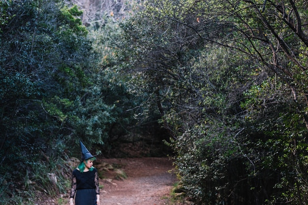 Free photo witch woman walking in woods