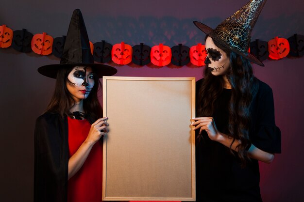 Witches holding whiteboard