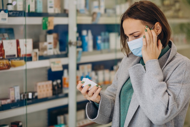 Free Photo womam customer with headache at pharmacy