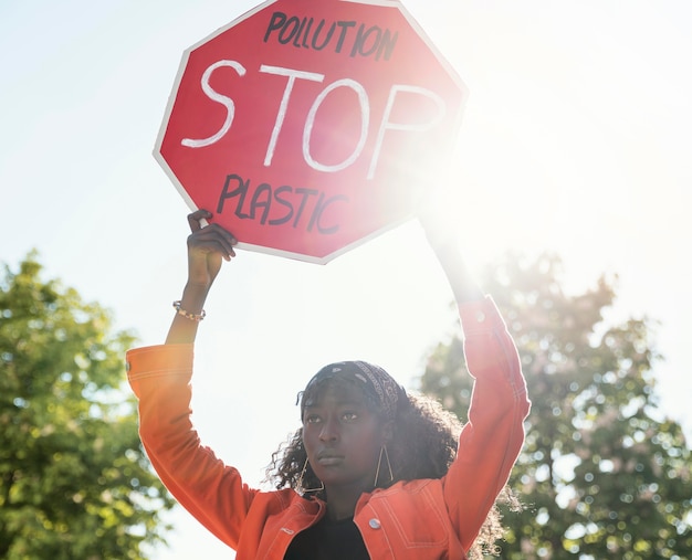 Free photo woman activist holding stop sign