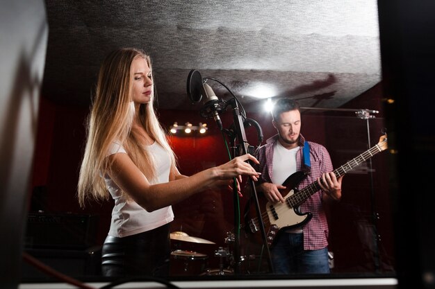 Woman adjusting the microphone stand long shot