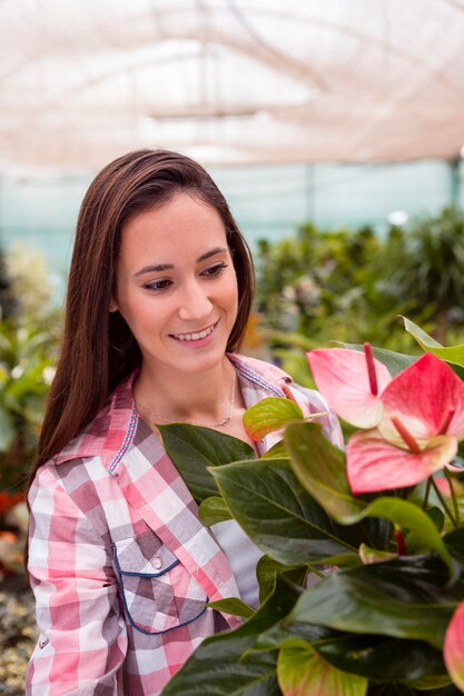 Woman admiring plants in garden