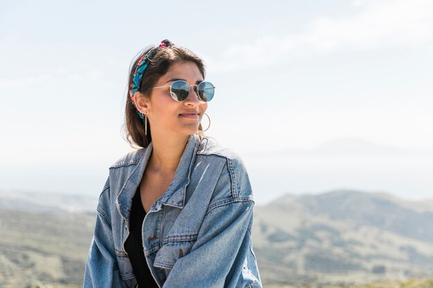 Woman against mountains looking away