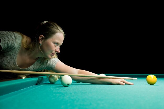 Woman aiming for billiard