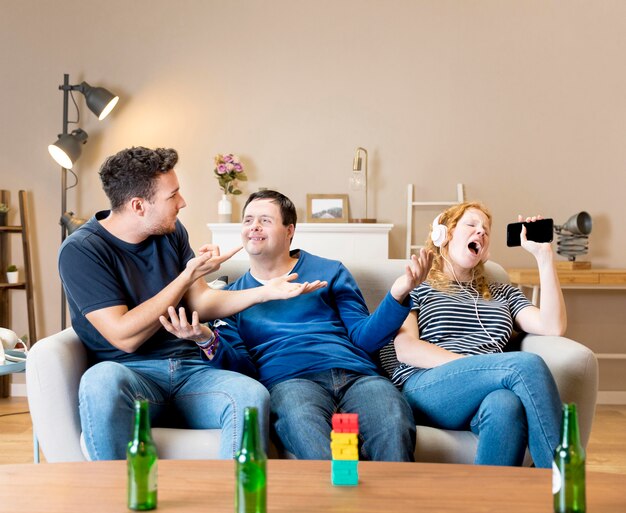 Woman annoying friends because she's singing loud while wearing headphones