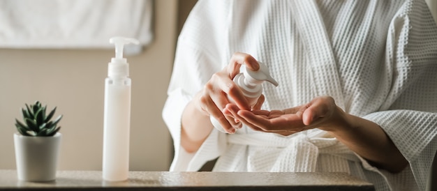 Woman apply the skincare gel in the bathroom. Premium Photo
