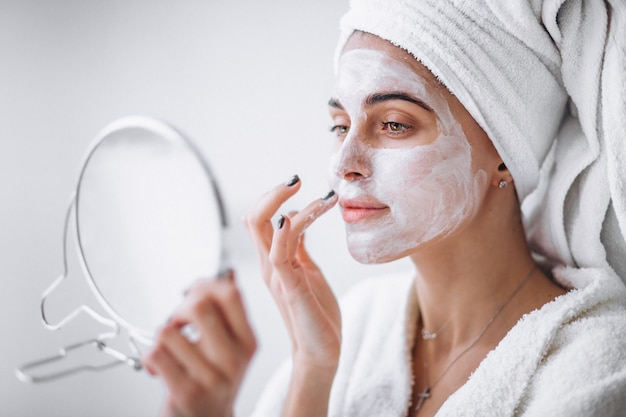 Woman applying  beauty mask