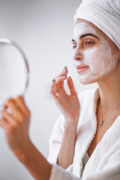 Woman applying beauty mask