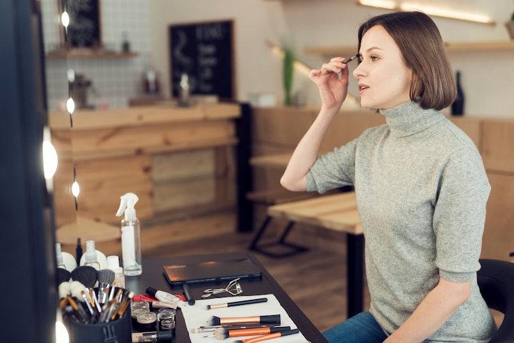 Free Photo woman applying eyebrow makeup
