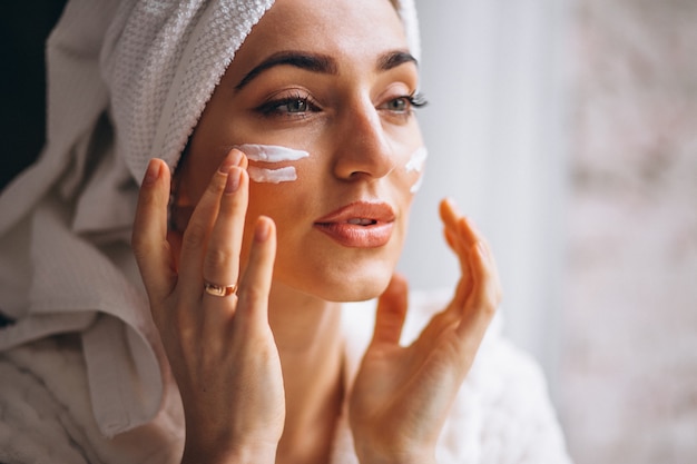 Woman applying face cream