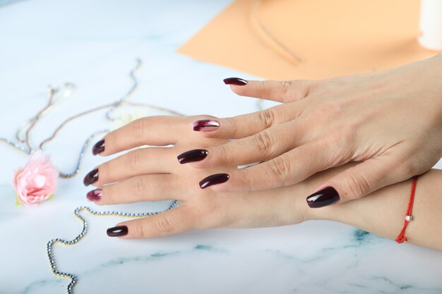 Woman applying hand cream to her hands and massaging