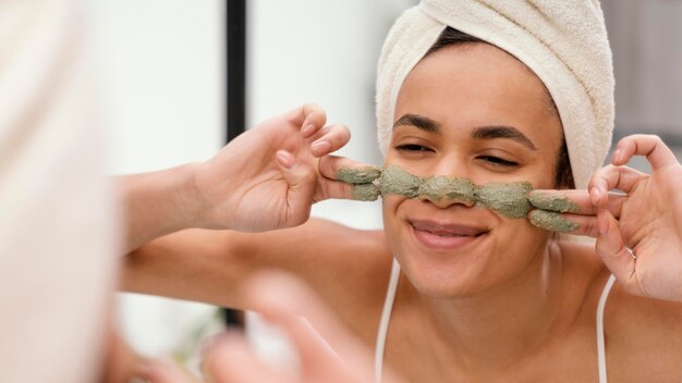 Woman applying a homemade treatment on her face