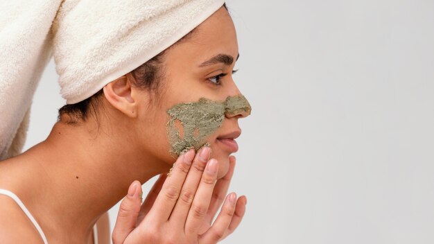 Woman applying a homemade treatment on her face