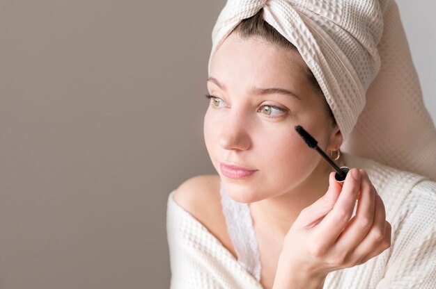 Woman applying mascara