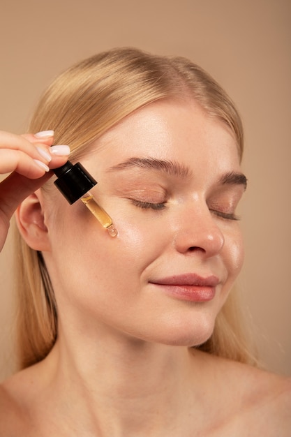 Free photo woman applying serum close up